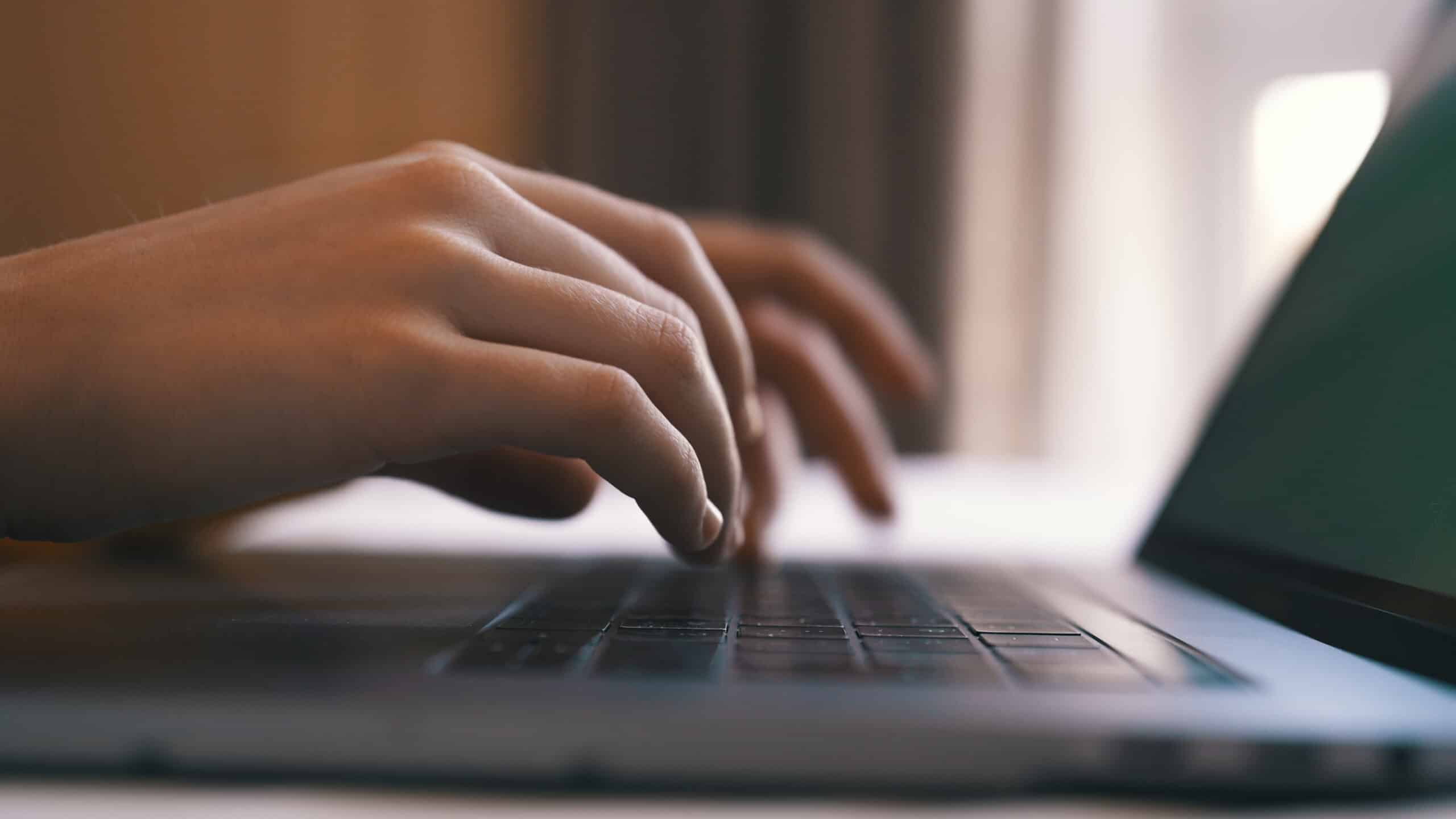 e-safeguarding monitoring child typing on laptop