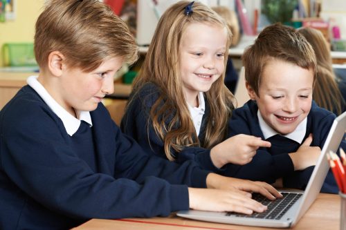 school children using laptop for education
